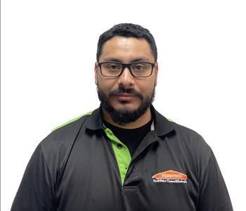 Crew Chief Guillermo Villafana smiling in front of a white wall.