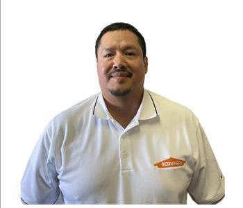 Male employee smiling against a white background.