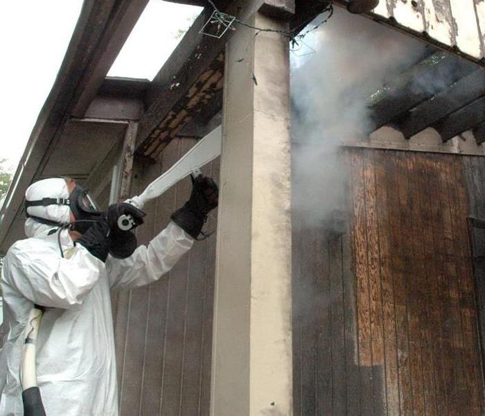 Worker using industrial cleaning equipment.